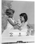 1930s two girls sisters at bathroom sink by Anonymous
