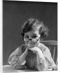 1930s portrait little girl smiling wearing big round eyeglasses looking at camera by Anonymous