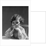1930s portrait little girl smiling wearing big round eyeglasses looking at camera by Anonymous