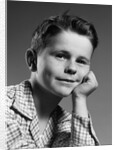 1950s child portrait boy with freckles posed resting head cheek on hand by Anonymous