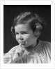 1930s little girl with finger to lips making quiet gesture looking at camera by Anonymous