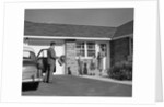 1950s family greeting father in driveway by Anonymous