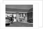 1950s family greeting father in driveway by Anonymous