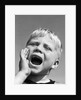 1950s blond boy with eyes closed and hand cupping a wide open mouth shouting by Anonymous