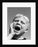 1950s blond boy with eyes closed and hand cupping a wide open mouth shouting by Anonymous