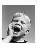 1950s blond boy with eyes closed and hand cupping a wide open mouth shouting by Anonymous