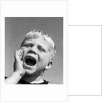 1950s blond boy with eyes closed and hand cupping a wide open mouth shouting by Anonymous
