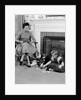 1950s mother watching son daughter playing game in front of fireplace by Anonymous