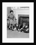 1950s mother watching son daughter playing game in front of fireplace by Anonymous
