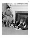 1950s mother watching son daughter playing game in front of fireplace by Anonymous
