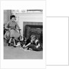 1950s mother watching son daughter playing game in front of fireplace by Anonymous