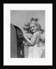 1930s 1940s child blond little girl with pigtails putting letter into mail box, looking at camera by Anonymous