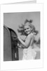 1930s 1940s child blond little girl with pigtails putting letter into mail box, looking at camera by Anonymous