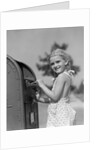 1930s 1940s child blond little girl with pigtails putting letter into mail box, looking at camera by Anonymous