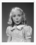 1940s 1950s blond girl whistling lips puckered eyes wide open looking at camera by Anonymous