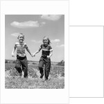 1950s boy girl running grassy farm field holding hands by Anonymous
