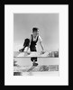 1940s brunette boy wearing overalls climbing over fence by Anonymous