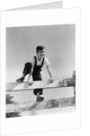 1940s brunette boy wearing overalls climbing over fence by Anonymous