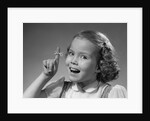 1950s little girl string tied on finger as reminder not to forget smiling looking at camera by Anonymous
