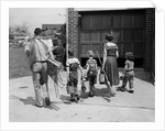 1950s family mother father 3 children from behind carrying gardening home improvement tools equipment by Anonymous