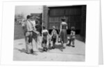 1950s family mother father 3 children from behind carrying gardening home improvement tools equipment by Anonymous