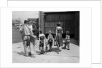 1950s family mother father 3 children from behind carrying gardening home improvement tools equipment by Anonymous