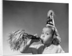 1950s girl wearing party hat blowing into noise maker looking at camera by Anonymous