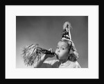 1950s girl wearing party hat blowing into noise maker looking at camera by Anonymous