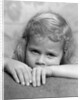 1930s portrait sad little blond girl peeking over her hands looking at camera by Anonymous