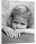 1930s portrait sad little blond girl peeking over her hands looking at camera by Anonymous