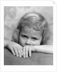 1930s portrait sad little blond girl peeking over her hands looking at camera by Anonymous