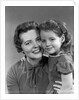 1950s girl daughter smiling hugging woman mother cheek to cheek together by Anonymous