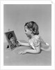 1940s child little girl looking at framed picture of her father a soldier in uniform by Anonymous