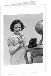 1930s child smiling girl putting money coin into toy cash register bank by Anonymous