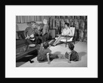 1960s family of four in living room boy is being disciplined by dad shaking finger by Anonymous