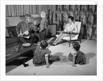 1960s family of four in living room boy is being disciplined by dad shaking finger by Anonymous