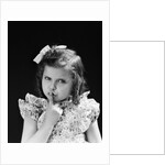 1950s child serious little girl pressing finger to lips hush be quiet secret by Anonymous