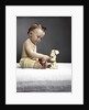 1940s 1950s baby sitting touching toy dog by Anonymous