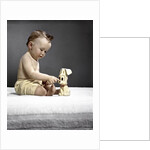 1940s 1950s baby sitting touching toy dog by Anonymous