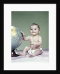 1960s smiling baby girl sitting in diapers hand touching world globe by Anonymous