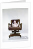 1960s chubby baby in diaper sitting in office executive chair by Anonymous