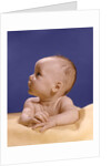1960s portrait of baby on yellow blanket resting on folded arms head turned to right looking up by Anonymous