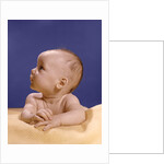 1960s portrait of baby on yellow blanket resting on folded arms head turned to right looking up by Anonymous