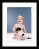 1960s smiling baby girl sitting in diapers playing with young black and white puppy dog by Anonymous