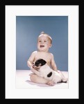 1960s smiling baby girl sitting in diapers playing with young black and white puppy dog by Anonymous