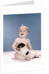 1960s smiling baby girl sitting in diapers playing with young black and white puppy dog by Anonymous