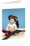 1960s baby boy wearing coonskin cap with stuffed animal and shotgun by Anonymous