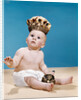 1960s baby wearing cloth diaper and crown holding a scepter by Anonymous