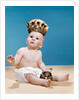 1960s baby wearing cloth diaper and crown holding a scepter by Anonymous