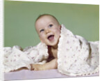 1960s smiling happy baby peeking out from under a blanket by Anonymous